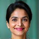 Portrait of Dr. Anita Sharma, a smiling woman in her 50s with warm, intelligent eyes, an expert in preventive medicine.